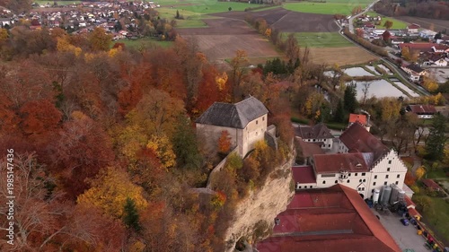 Aerial view of the medieval cave castle Schloss Stein an der Traun in Bavaria, Germany. Historic site near Stadt Traunreut in the Trauntal valley.