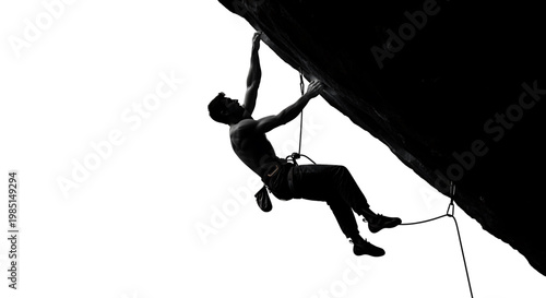 A man climbing a rock face with ropes and harness in a dramatic pose