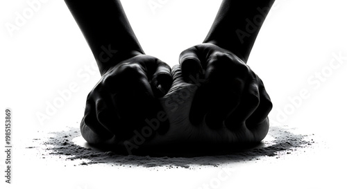 A pair of hands clenched into fists with dirt scattered around them on a white background