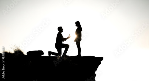 A romantic proposal scene on a cliff edge at sunset with a man kneeling and holding out a ring to his girlfriend in a serene and peaceful atmosphere.