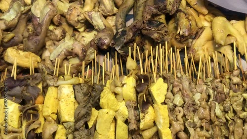 A close-up view of a variety of grilled and skewered meats and vegetables, likely at a street food market.