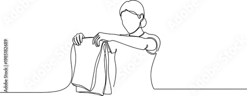 Continuous line drawing of a person holding and folding a t-shirt, minimalist style