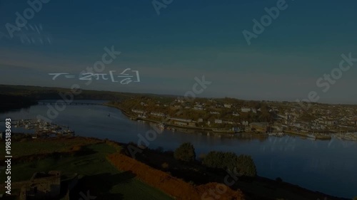 Aerial camera moving forward, showing river town while math symbols layering over water for science