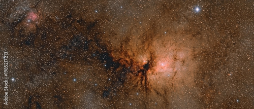 Glowing orange and red nebulae interwoven with intricate dark dust clouds, against a backdrop of countless distant stars