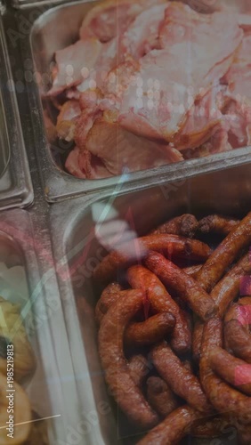 Overlay appearing camera panning over metal pans, revealing sausage and sliced ham showing display
