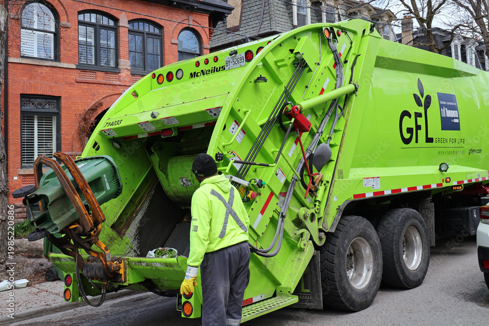 Naklejka premium Toronto garbage truck loading compostable food waste bin