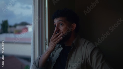 Sad woman looking through a window