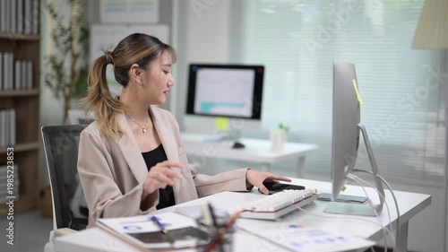 Young Professional Woman Working at Desk in Modern Office Environment