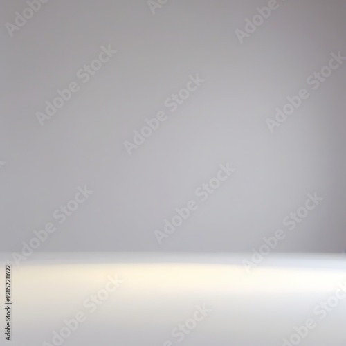 Blurred gray background with white floor and spotlight