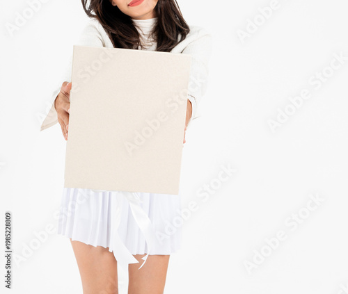 Asian woman body in white short skirt holding plain gift box, isolated on white background