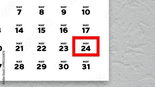 The date May 24th marked with a red cursor on the wall calendar 2026