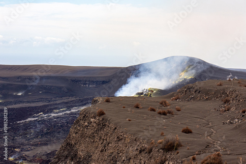 Tableau sur toile Steaming fumarole with yellow sulfur deposits on the edge of a volcanic crater i