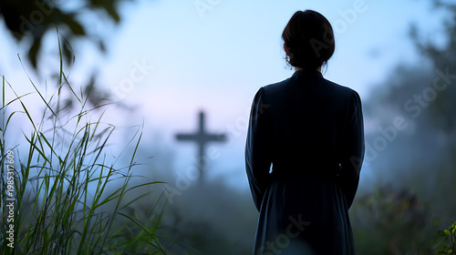 A solemn figure stands silhouetted against a misty dawn, facing a solitary cross. The scene evokes a sense of contemplation, remembrance, and quiet reverence.