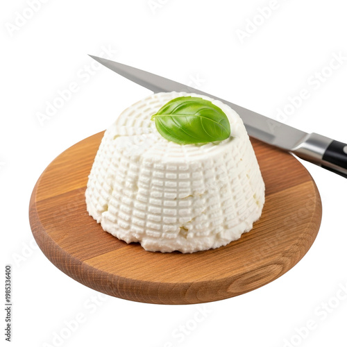 Ricotta cheese with basil on a wooden board and knife