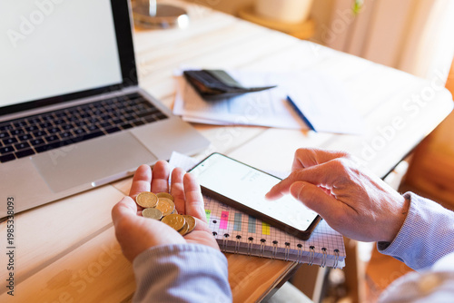 Financial problems, person counting coins, and checking finances on phone