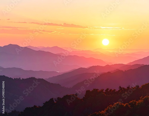 A scenic vista of layered mountain ranges bathed in the warm glow of a setting sun. The sky is ablaze with vibrant hues