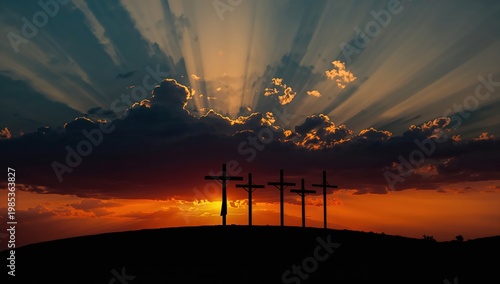 Crosses standing against sunset sky with warm light rays producing dramatic and meaningful composition