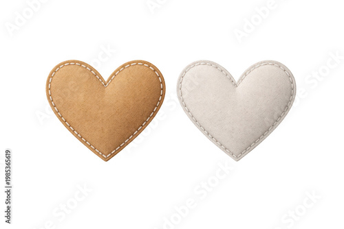 Pair of heart shaped fabric patches with stitched edges in tan cork and white fluffy on transparent background