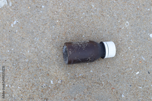 Plastic water bottles thrown on the sand, plastic pollution and broken bottle. Climate change issues with the plastic wastes and bottle waste.