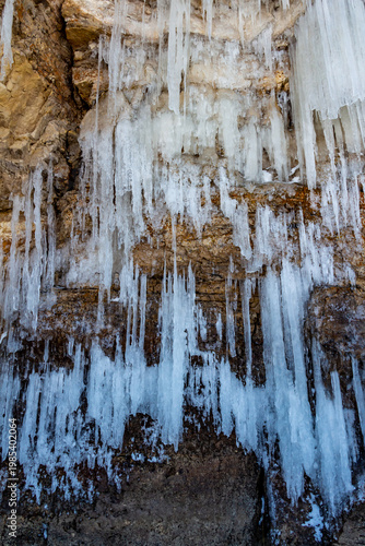 Large icicles hang from the steep cliffs.
