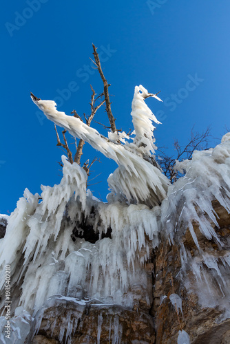 Large icicles hang from the steep cliffs.