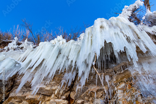 Large icicles hang from the steep cliffs.