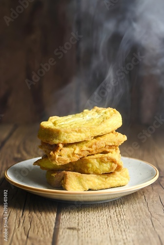 Crispy Fried Tempeh Stack with Steam on Rustic Wooden Table