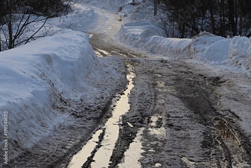 Early spring in a Russian village, rural road, spring thaw