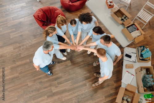 Volunteers joining hands showing teamwork and community spirit