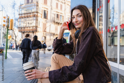 Young woman urban lifestyle talking on smartphone outside