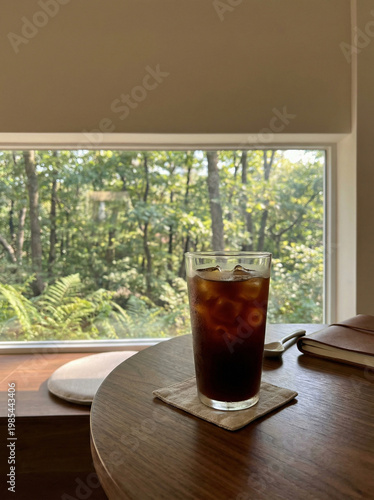 Iced Coffee by Window with Forest View – Relaxing Café and Nature Lifestyle Concept