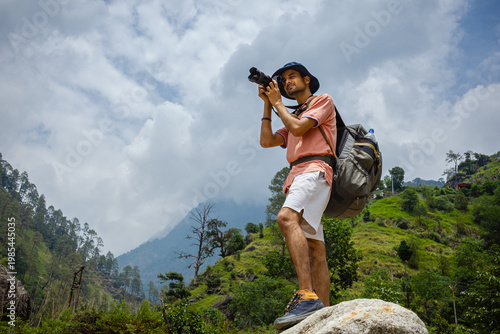 Photography A man taking a photo with his camera in Madhyamaheshwar temple, Uttarakhand, ind