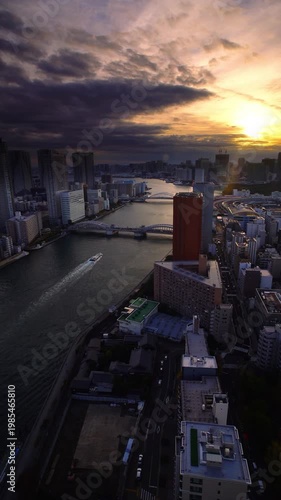 隅田川と勝どき橋とベイエリア方向のビル群と船と夕日