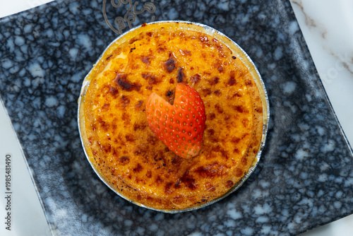 Classic creme brulee dessert with strawberry