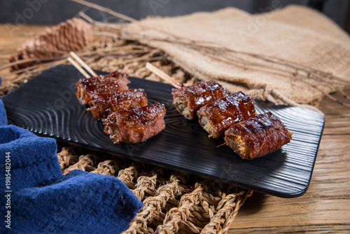 Bacon wrapped enoki mushroom skewers on platter
