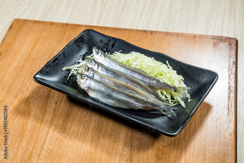Chilled small whole fish on cabbage bed