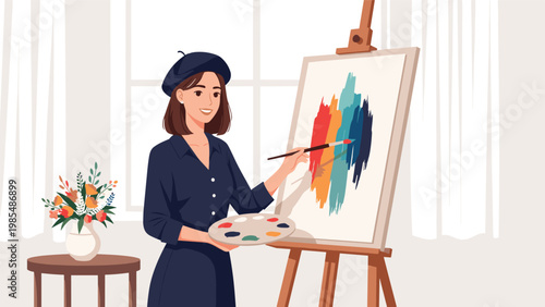 Creative female artist in a black beret paints an abstract colorful masterpiece on a canvas in her bright studio.