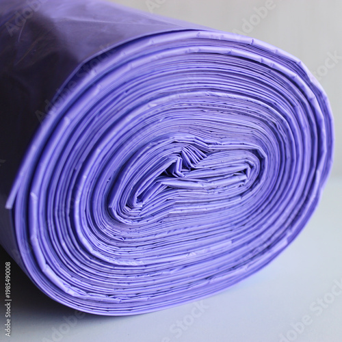 Tightly rolled plastic garbage bags close up square stock photo 
