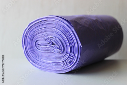 Roll of Violet Plastic Bags for Domestic Waste on White Shelf Detailed View 
