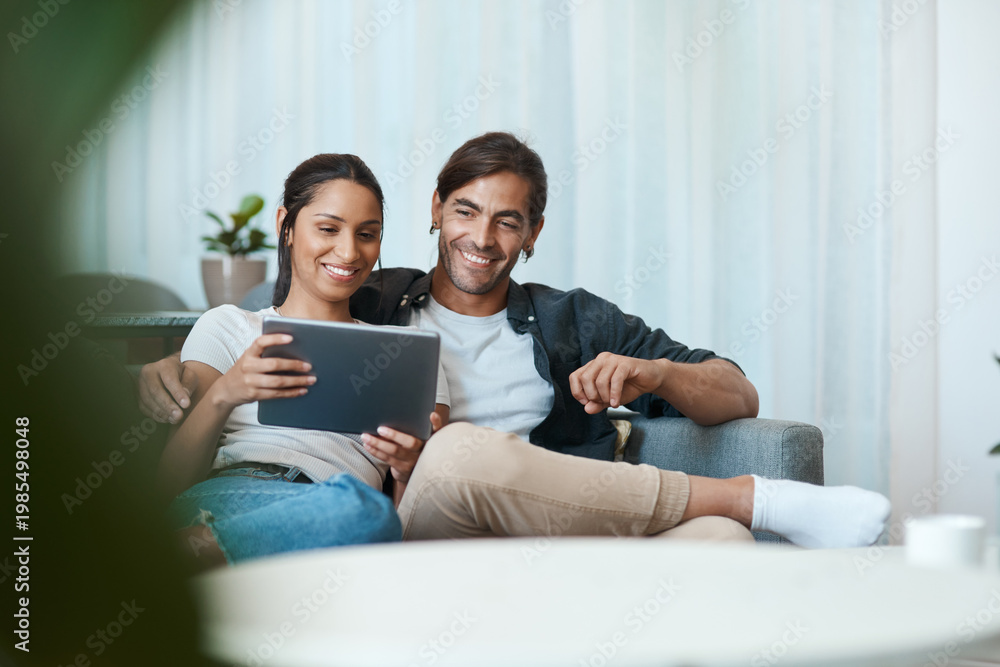 Obraz premium Happy couple, tablet and relax on sofa in home with streaming, video and bonding with love in lounge. People, partner and interracial relationship with tech, app and smile with subscription at house