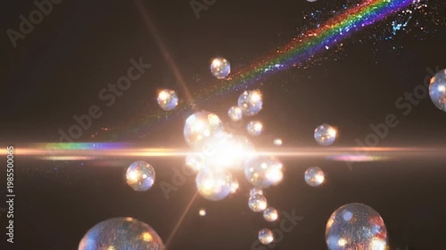 Elegant lens flare on black backdrop concept. Bright glowing rainbow light trail with sparkling bubbles and particles on dark background vibrant colorful energy