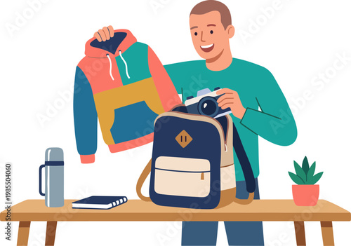 Man packing clothes and books into backpack on wooden table indoors