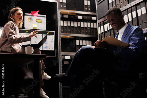 Cuadro en lienzo Diverse colleagues working in federal bureau, analyzing crime scene evidence discussing criminology report