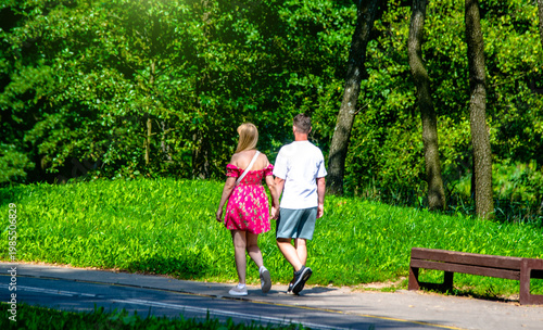Wallpaper Mural A guy and a girl walk along the path in the city Park Torontodigital.ca