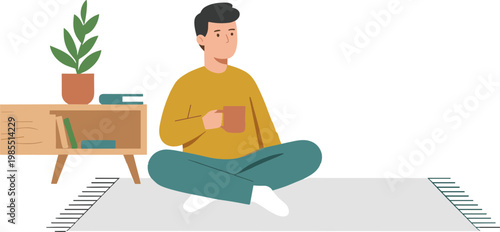 A man sits cross-legged on a rug in a room with a plant and furniture