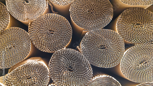 Foto Rolled corrugated cardboard sheets stacked in circular bundles