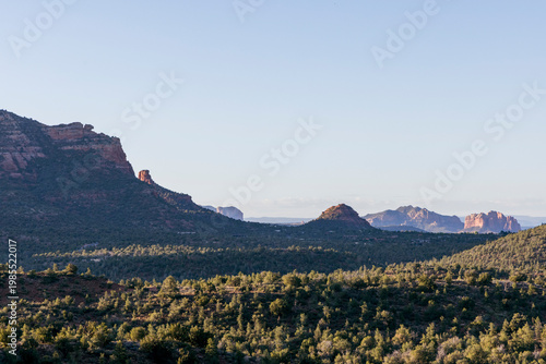 Open rugged forested desert landscape and distant formations
