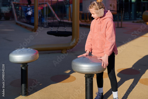 Girl playing musical instrument on playground