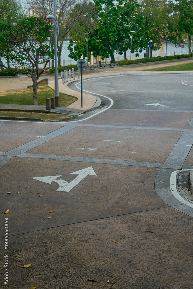 Obraz premium A top-down perspective of white painted directional arrows on a clean asphalt road surface, symbolizing guidance, choices, and forward movement.