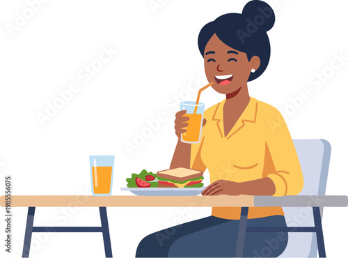 A woman sits at a table happily eating a sandwich and drinking juice